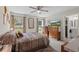 Bedroom with a TV, a ceiling fan, and an attached bathroom at 4661 Sw Gardenia Ct, Dunnellon, FL 34431