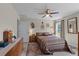 Bedroom with a ceiling fan, curtains, and several photos on the wall at 4661 Sw Gardenia Ct, Dunnellon, FL 34431