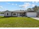 Charming single-story home boasts a manicured lawn, attached garage, and modern design at 4661 Sw Gardenia Ct, Dunnellon, FL 34431