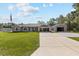Charming single-story home boasts a manicured lawn, large driveway and detached two-car garage at 4661 Sw Gardenia Ct, Dunnellon, FL 34431