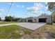Single-story home with a well-maintained lawn, long driveway and detached two-car garage at 4661 Sw Gardenia Ct, Dunnellon, FL 34431