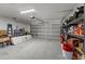 Spacious garage with room for parking and storage, featuring ample shelving at 4661 Sw Gardenia Ct, Dunnellon, FL 34431