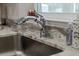 Close-up of the stainless steel sink with elegant faucet and granite countertops at 4661 Sw Gardenia Ct, Dunnellon, FL 34431