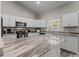 Well-equipped kitchen with granite countertops and white cabinets at 4661 Sw Gardenia Ct, Dunnellon, FL 34431