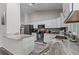 Bright kitchen with granite countertops, white cabinets, and stainless steel appliances at 4661 Sw Gardenia Ct, Dunnellon, FL 34431