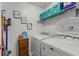 Clean laundry room with washer, dryer, storage, and shelving at 4661 Sw Gardenia Ct, Dunnellon, FL 34431