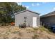 Durable gray metal shed in backyard with door, window, and lawn equipment visible at 4661 Sw Gardenia Ct, Dunnellon, FL 34431