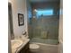 A bathroom features a tub shower combo, and decorative tile work above the window at 530 Casteel Ave, The Villages, FL 32163