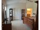 A well-lit bedroom boasts tile floors, ensuite bathroom, vaulted ceiling and decorative furniture at 530 Casteel Ave, The Villages, FL 32163