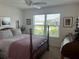 Bright bedroom features a ceiling fan, wooden furniture and a view of the neighborhood at 530 Casteel Ave, The Villages, FL 32163