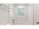 This bathroom features a shower-tub combo with sleek white tiling at 5740 Nw 61St St, Ocala, FL 34482