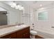 Bright bathroom featuring a vanity with granite countertop and a shower-tub combo at 5740 Nw 61St St, Ocala, FL 34482