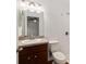Bathroom featuring a vanity with an undermount sink, white toilet, and tiled shower at 5740 Nw 61St St, Ocala, FL 34482