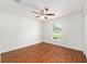 This bedroom features bright natural light, wood floors and a ceiling fan at 5740 Nw 61St St, Ocala, FL 34482