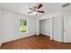 Bright bedroom with wood floors, ceiling fan, and closet at 5740 Nw 61St St, Ocala, FL 34482