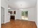 Bright dining room featuring sliding glass doors and wood-look floors, adjacent to the kitchen at 5740 Nw 61St St, Ocala, FL 34482