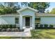 Inviting entrance with a covered porch and manicured landscaping leading to the front door at 5740 Nw 61St St, Ocala, FL 34482