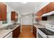Open kitchen featuring wood cabinets and view to the living and dining areas at 5740 Nw 61St St, Ocala, FL 34482
