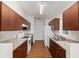 Traditional style kitchen with wood cabinets, laminate countertops and white appliances at 5740 Nw 61St St, Ocala, FL 34482