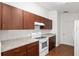 Traditional style kitchen with wood cabinets, laminate countertops and white appliances at 5740 Nw 61St St, Ocala, FL 34482