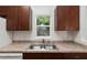 Bright kitchen detail showcasing stainless steel sink and wood cabinets at 5740 Nw 61St St, Ocala, FL 34482