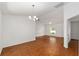 Bright, open living room with wood-look floors, ceiling fan and a large window at 5740 Nw 61St St, Ocala, FL 34482