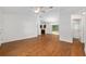 Open-concept living area with hardwood floors, leading to the kitchen and bathroom at 5740 Nw 61St St, Ocala, FL 34482