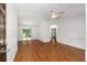 Bright living room featuring hardwood floors, a ceiling fan, and access to the backyard at 5740 Nw 61St St, Ocala, FL 34482