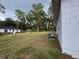 Large backyard view highlighting green space with trees, along with home's AC unit at 6422 Nw 62Nd Pl, Ocala, FL 34482