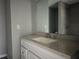 Bright bathroom with a granite vanity, large mirror, and gray tiled shower at 6422 Nw 62Nd Pl, Ocala, FL 34482