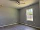 Bedroom featuring wood-look floors, neutral paint, a ceiling fan, and a window offering natural light at 6422 Nw 62Nd Pl, Ocala, FL 34482