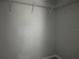 Walk-in closet with white wire shelving, neutral walls, and gray wood-look floors at 6422 Nw 62Nd Pl, Ocala, FL 34482