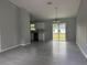 Open-concept living space with tile floors, grey walls, and a view of the kitchen at 6422 Nw 62Nd Pl, Ocala, FL 34482