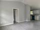 View of living room into kitchen, featuring tile floors, gray walls, and white door at 6422 Nw 62Nd Pl, Ocala, FL 34482