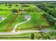 Aerial view of a sprawling property with a long driveway and mature trees, surrounded by fencing at 7041 Ne 22Nd Court Rd, Ocala, FL 34479