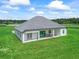 Aerial view of the modern home showcasing the expansive backyard and covered patio areas at 7041 Ne 22Nd Court Rd, Ocala, FL 34479