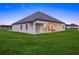 A sprawling backyard featuring lush green grass and a covered patio of this stunning single-story home at 7041 Ne 22Nd Court Rd, Ocala, FL 34479