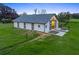This barn features a white exterior, grey roof, and is surrounded by lush, green grass at 7041 Ne 22Nd Court Rd, Ocala, FL 34479