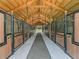 Well-maintained barn interior with wooden beams, individual stalls, and a central walkway for easy access at 7041 Ne 22Nd Court Rd, Ocala, FL 34479