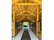 Spacious interior of a modern barn with wooden stalls and high ceilings at 7041 Ne 22Nd Court Rd, Ocala, FL 34479