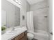 Bright bathroom featuring marble-look tiled shower/tub, stylish vanity, and modern fixtures at 7041 Ne 22Nd Court Rd, Ocala, FL 34479