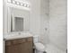 Bright bathroom featuring a marble-look tiled shower, stylish vanity, and modern fixtures at 7041 Ne 22Nd Court Rd, Ocala, FL 34479