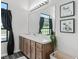 Updated bathroom with wooden cabinets, a large mirror, and plants for a spa-like feel at 7041 Ne 22Nd Court Rd, Ocala, FL 34479