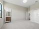 Spacious bedroom with carpet, ensuite bathroom, and large window with view at 7041 Ne 22Nd Court Rd, Ocala, FL 34479