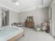 Spacious bedroom with neutral decor, carpet flooring, tray ceiling, and a cozy seating area for relaxing and unwinding at 7041 Ne 22Nd Court Rd, Ocala, FL 34479