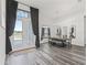 Bright dining room with hardwood floors, modern chandelier and ample windows at 7041 Ne 22Nd Court Rd, Ocala, FL 34479