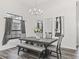 Dining room boasts a modern chandelier, neutral walls, and gray furniture set at 7041 Ne 22Nd Court Rd, Ocala, FL 34479