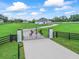 Aerial shot of the gated entrance featuring horse silhouettes and manicured grounds at 7041 Ne 22Nd Court Rd, Ocala, FL 34479