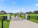 Gated entrance of home, featuring pillars and horse themed gate to ensure maximum privacy at 7041 Ne 22Nd Court Rd, Ocala, FL 34479
