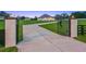 Elegant gated entrance with long drive leading to a well-manicured lawn and stunning modern farmhouse at 7041 Ne 22Nd Court Rd, Ocala, FL 34479